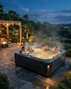 Luxury hot tub on a modern backyard patio at night