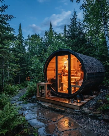 Modern outdoor barrel sauna in a forest setting