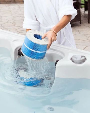 Lifting a pleated filter from a hot tub housing for routine maintenance