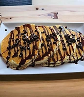 Chocolate chip pancakes plated on white platter