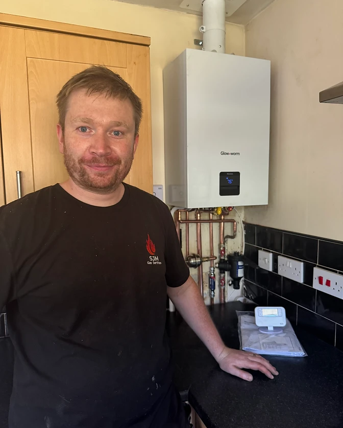 S J Meakin Gas Safe engineer with a Glow-worm boiler installation