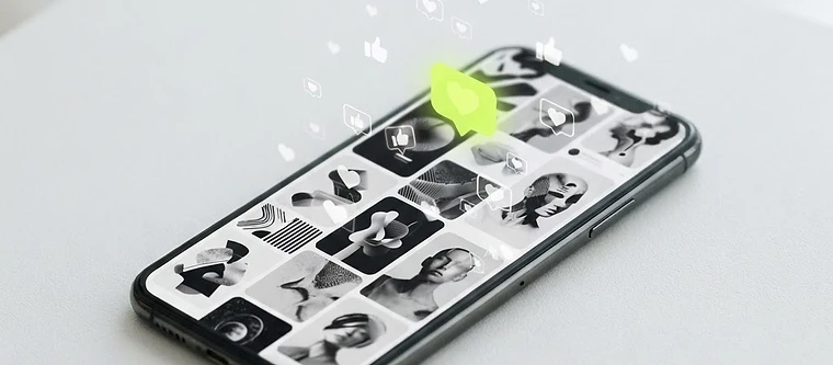 A smartphone showing a social media feed with floating like and heart icons