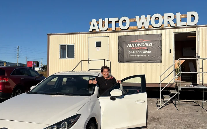 Woman with white Mazda sedan