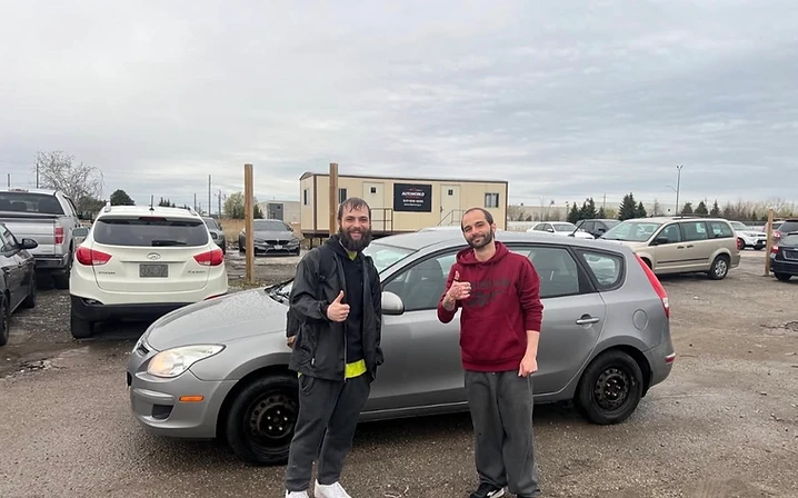 Two customers with silver hatchback