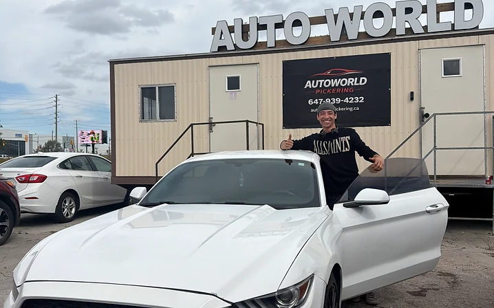 Man with white Ford Mustang