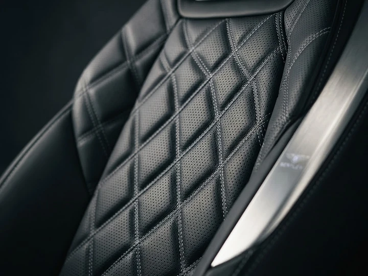 Diamond-stitched leather seat and brushed trim finished by hand