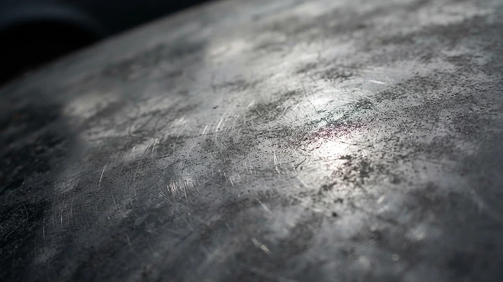 Vehicle paint before correction showing swirl marks and dull, hazy clear coat