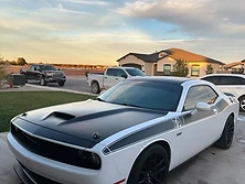Black muscle car with a deep mirror-gloss finish after paint correction detailing
