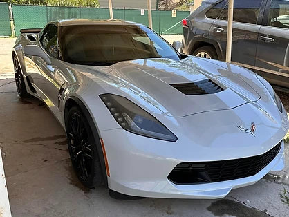 Corvette receiving a full exterior detail inside a residential carport