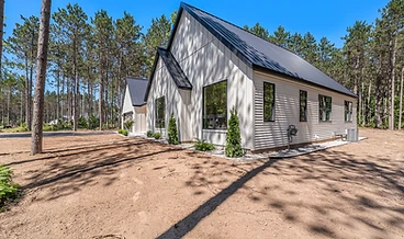 Single-story home with white board-and-batten siding and a standing-seam metal roof