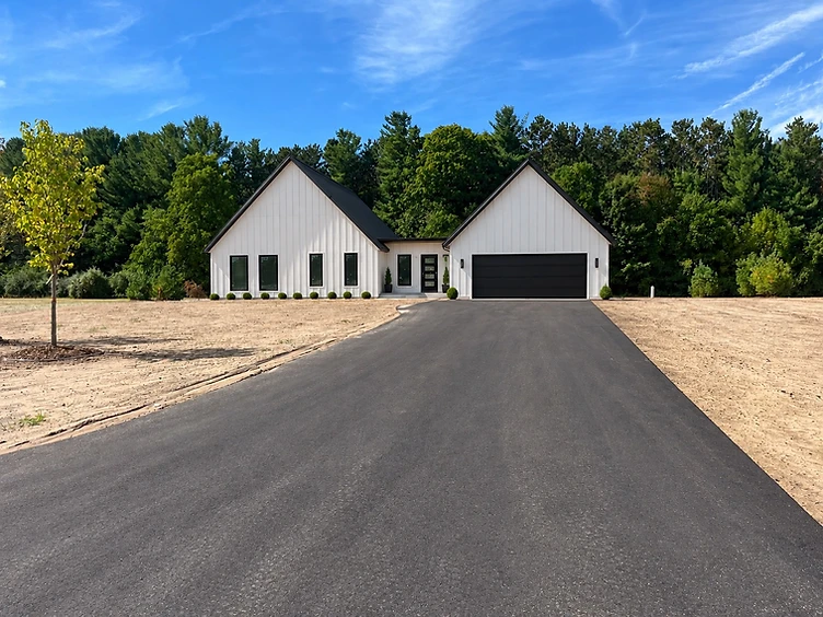 Norway model home at 4141 Fireside Trail with white board-and-batten siding and black metal roof