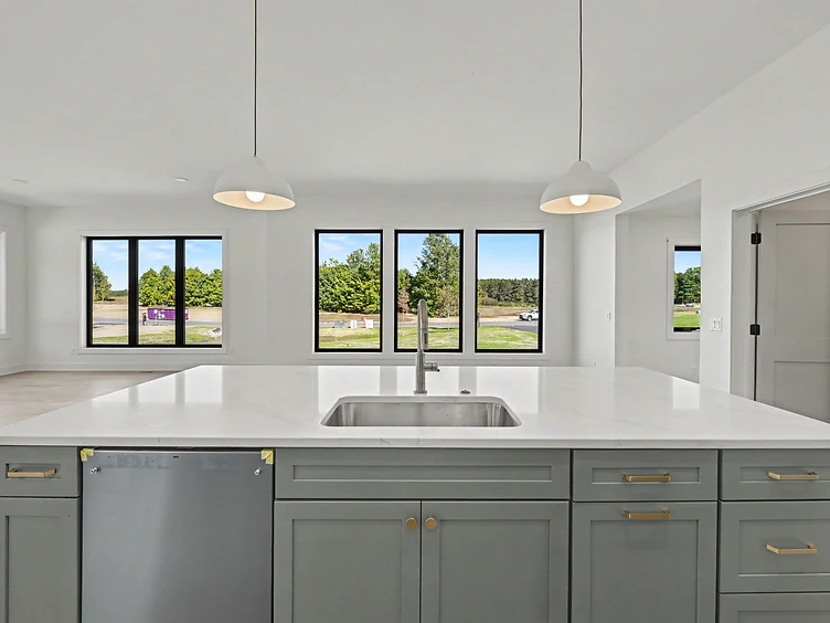 Halmstad kitchen with blue-grey island, white countertop, and pendant lights