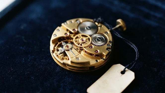 Brass watch mechanism with a small ivory maintenance tag
