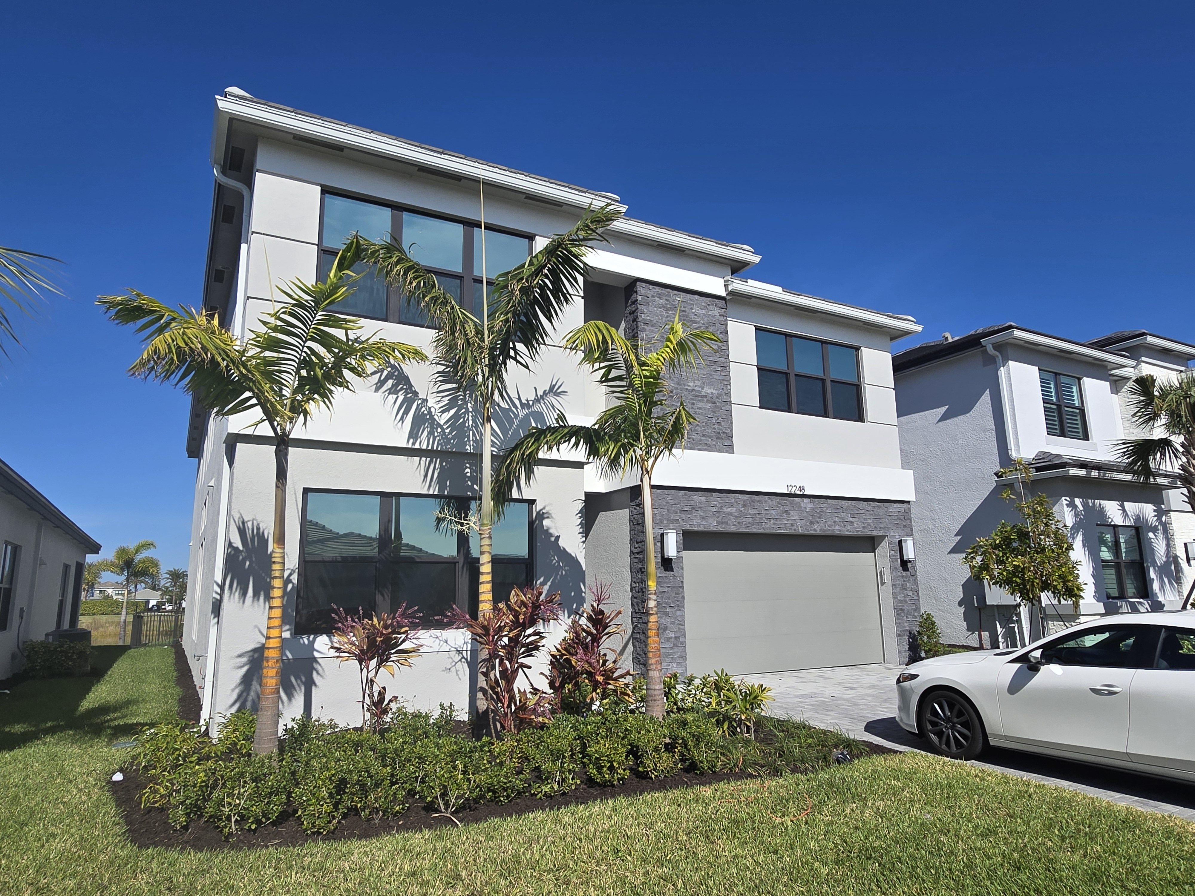 Modern Southwest Florida home with tinted windows at dusk