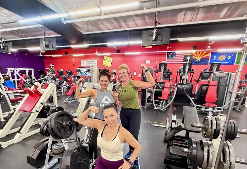 Members flexing on the Summit Fitness gym floor