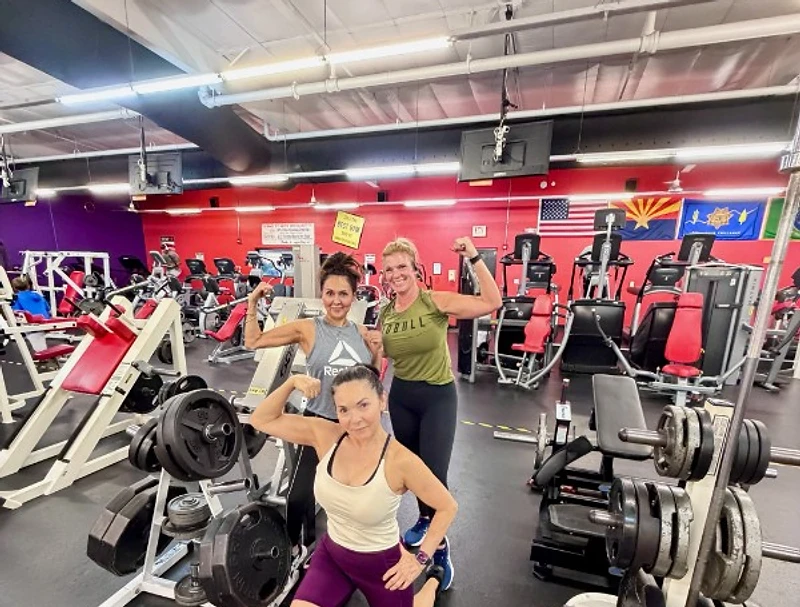 Members flexing on the Summit Fitness gym floor
