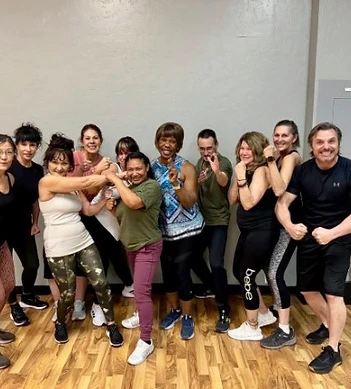 Body Combat class members flexing together after a session