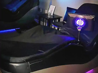 Hydromassage recovery bed in a dark wellness room