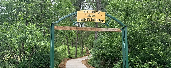 Jeanne's Tale Trail sign installed at the trailhead archway
