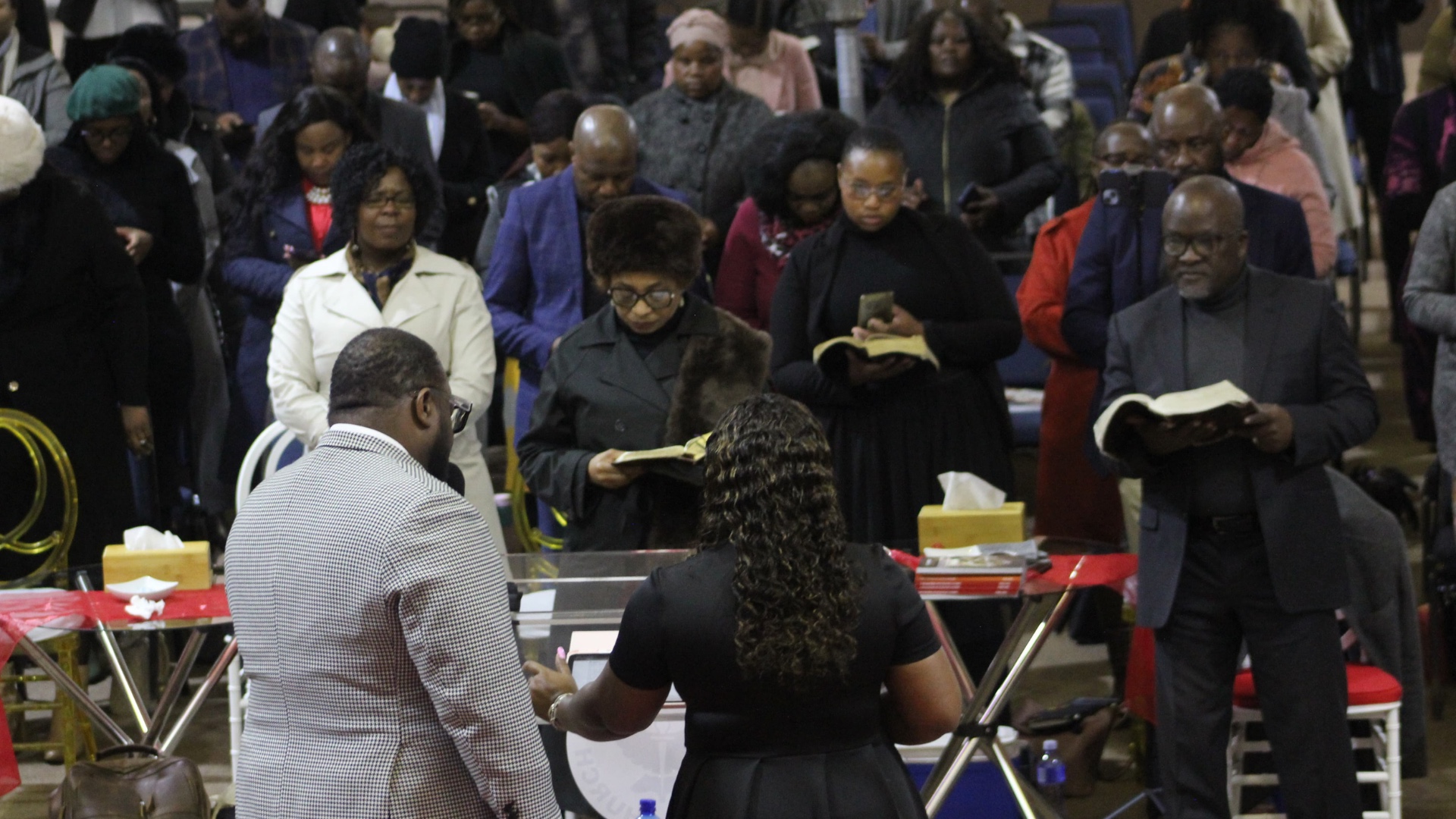 Congregation reading scripture together during a service