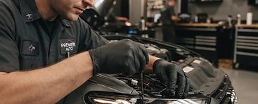 Mechanic working on a car headlight