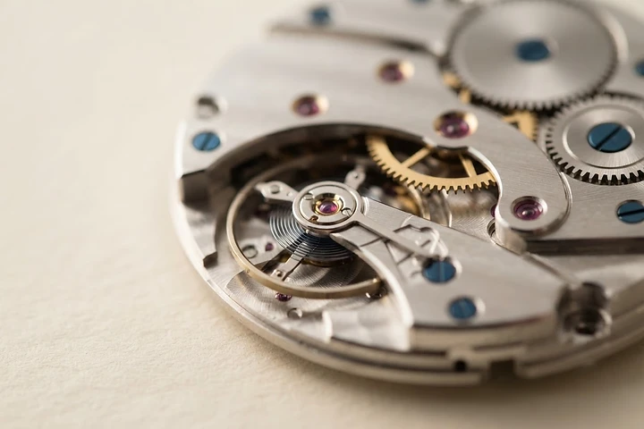 Macro photograph of a precision watch movement representing engineered detail