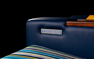 Muse control panel set into a navy leather armrest