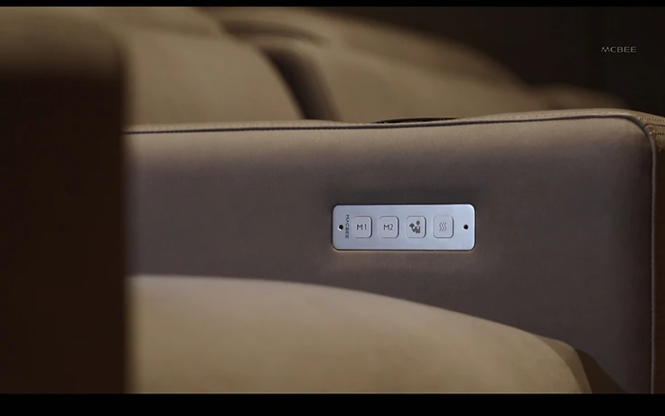 Monolith integrated armrest control panel in soft upholstery