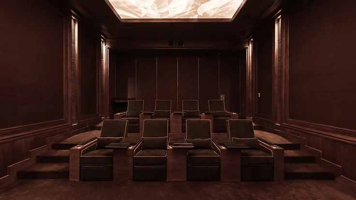 Atelier seating within a warm, wood-panelled private cinema