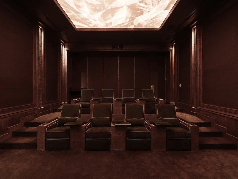 SEATLAB private cinema — tiered seating in warm, cinematic light
