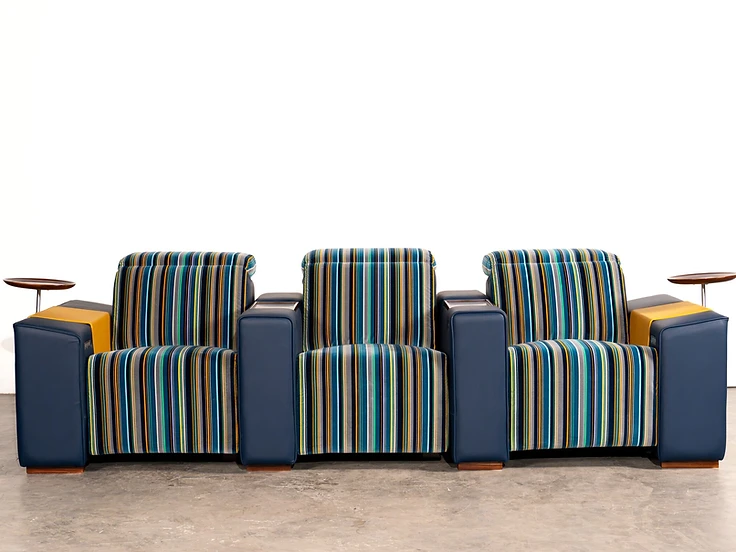 Muse row of three seats — architectural proportions in striped textile and leather