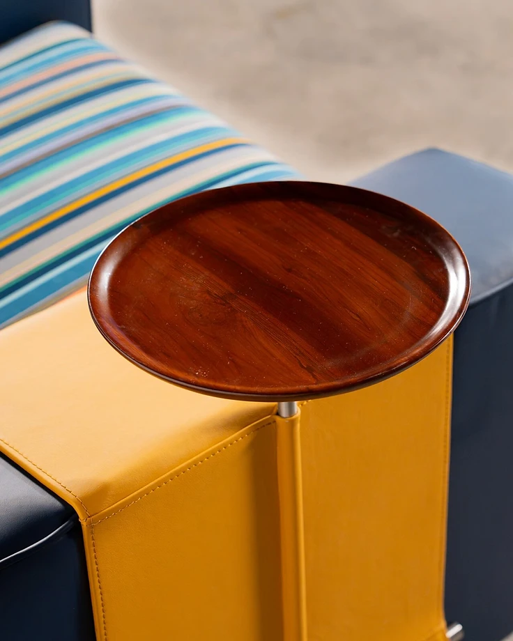 Muse — warm timber tray table and marigold leather detail