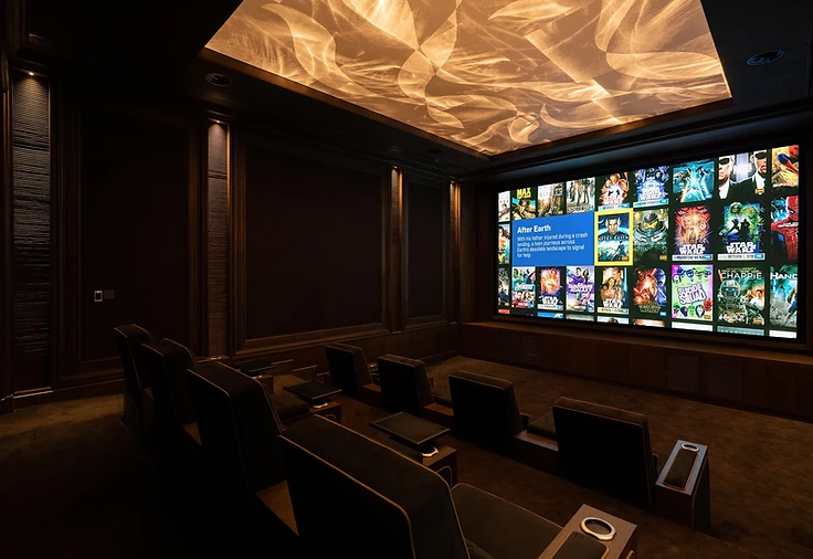 Atelier private cinema — wide architectural view toward the screen
