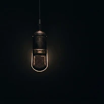 A vintage microphone alone in darkness