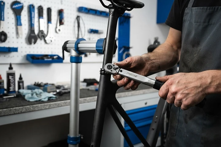 Technician precisely adjusting a bicycle
