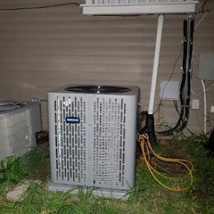 Amana air conditioner condenser installed next to vinyl siding