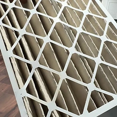 New pleated HVAC air filter ready for a replacement visit