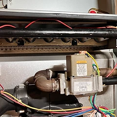 Furnace burner assembly and gas valve during a heating repair