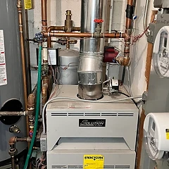 Refrigerant leak test with soap bubbles on a copper line before repair