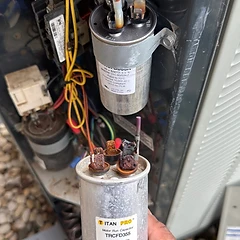 Run capacitor replacement — new vs corroded capacitor during AC repair