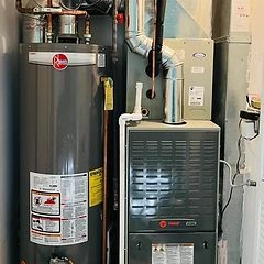 Rheem water heater and Trane furnace installation in a utility closet