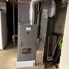 Ruud high-efficiency furnace installed in a basement utility room