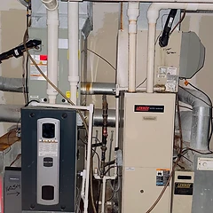 American Standard and Lennox furnaces installed side-by-side in a mechanical room
