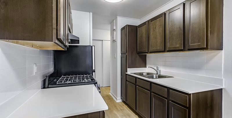 Renovated galley kitchen with new cabinetry, countertop and tile backsplash at Berry Street, Williamsburg