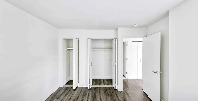 Renovated bedroom with new plank flooring, closet doors and fresh paint at 672 Ralph Avenue, East Brooklyn