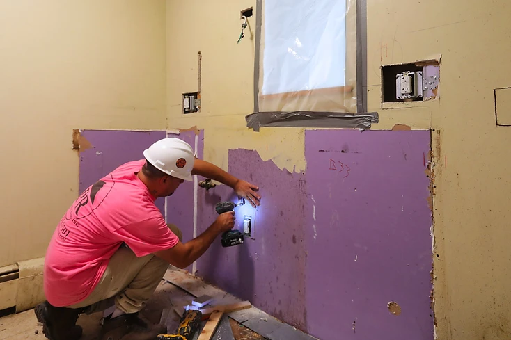 Renovation work underway inside an occupied apartment during the PACT Renaissance Collaborative project in Upper Manhattan
