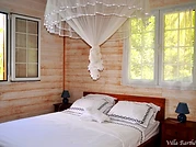 The bedroom, queen-size bed and mosquito net