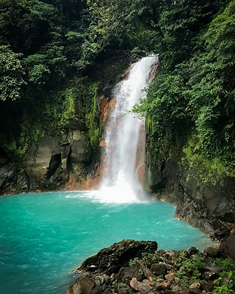 Turquoise waterfall pool in the Costa Rica rainforest