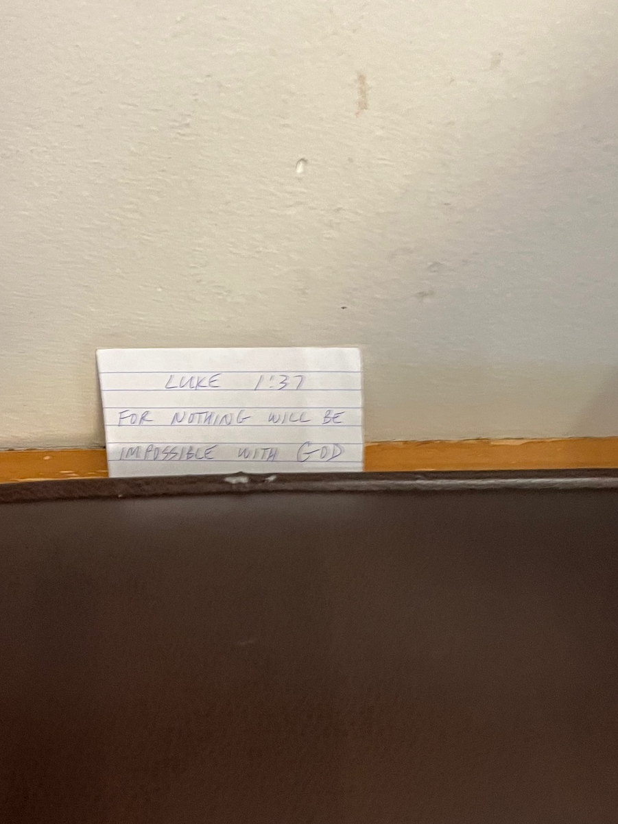 A real Verse Scrap tucked between a wall and a leather bench