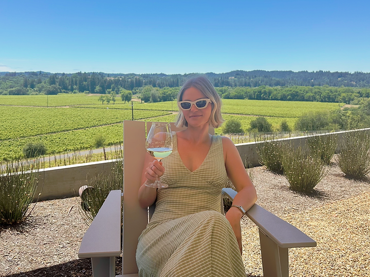 Ashley pouring natural wine at a communal table in Sonoma County